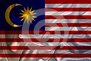 Beautiful photo of the national flag of Malaysia on delicate shiny silk with soft draperies, the concept of state power, country