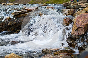 Beautiful photo of a small falls through boulders making a brook from a lake in the mountains of Snowdonia, Wales