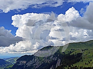 Beautiful photogenic clouds over the Iberig region and slopes of the Schwyz Alps mountain massif, Oberiberg - Canton of Schwyz