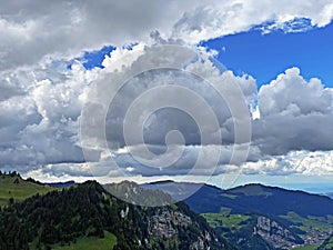 Beautiful photogenic clouds over the Iberig region and slopes of the Schwyz Alps mountain massif, Oberiberg - Canton of Schwyz