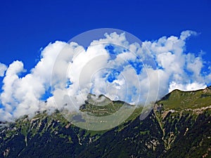 Beautiful photogenic clouds over Lake Brienz Brienzersee and the surrounding alpine peaks - Canton of Bern, Switzerland