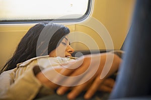 Beautiful photograph of peaceful young caucasian woman resting and enjoying being alone on the train