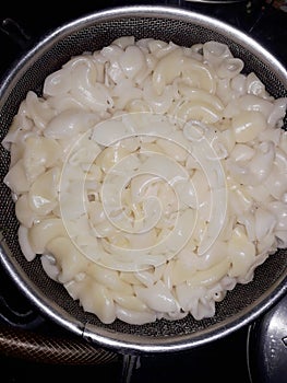 This beautiful pic of boiled macarone in strainer. .