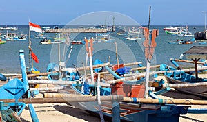 Beautiful picture of fishing boats at Jimbaran Bay at Bali Indonesia, beach, ocean, fishing boats and airport in photo.
