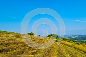 Beautiful picturesque view of the slope of rural fields in the mountainous area.