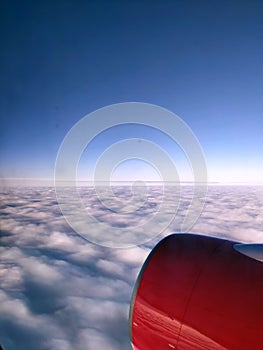 Beautiful picturesque view from the window of the aircraft. Sky. View from the Illuminator. Vertical photo. Copy space