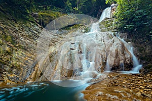 Beautiful and Picturesque Waterfall In Deep Forest In Summer Closeup