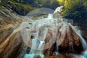 Beautiful and Picturesque Waterfall In Deep Forest In Summer Closeup