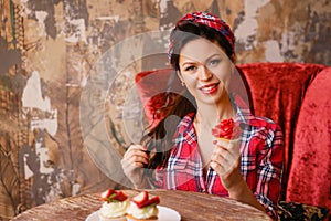 Beautiful pin-up woman sitting at a table in a cafe
