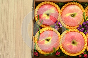 beautiful pink apple in the box on wood floor, healthy fruit
