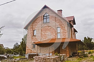 Beautiful pink brick brick house and orange roof. Corrugated met