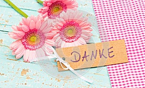 Beautiful pink bunch of flowers and card with german word, Danke, means thank you