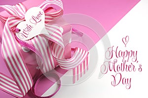 Beautiful pink gift on pink and white background with sample text and copy space for your text here for Mothers Day