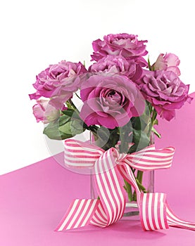 Beautiful pink gift of roses on pink and white background