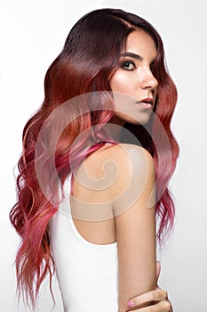 Beautiful pink-haired girl in move with a perfectly curls hair, and classic make-up. Beauty face.