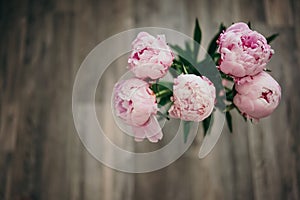 Beautiful pink peonies bouquet on gray floor background