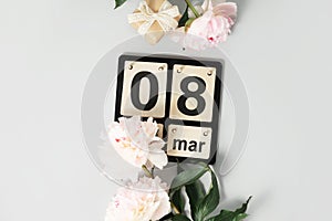 Beautiful pink peony flowers and calendar on white background