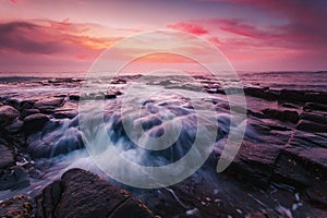 Sunrise at the tessellated rocks of Garie Beach Australia photo