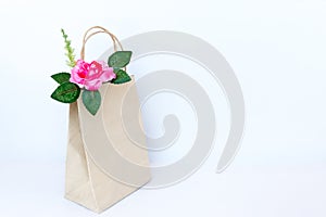 Beautiful pink roses in brown paper bag isolated on the white b