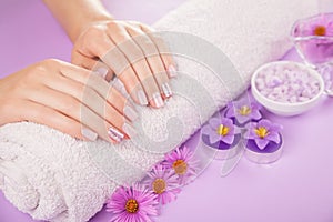 Beautiful pink and silver manicure with flowers and spa essentials