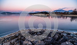 A beautiful pink sky in the cold morning during sunrise on a lake. Winter landscape in bright colors.Dam Liptovska Mara, Slovakia