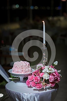 beautiful pink wedding cake. white vintage wedding cake on wooden table