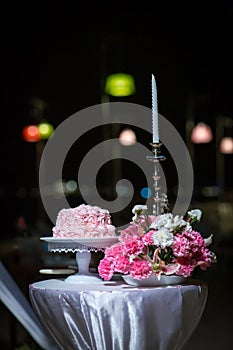 Beautiful pink wedding cake. white vintage wedding cake on wooden table