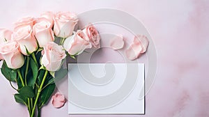 Beautiful pink and white rose flower bouquet and blank note paper on pink backdrop, Mothers day and Valentine s day background.