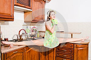 Beautiful pinup woman doing splits in kitchen