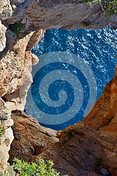 Beautiful Pirates Cave in Spain near Calpe, orange rock and blue sea.