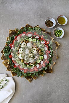 Beautiful plate display of homemade Labane cheese balls with Olive oil, za`atar pita bread toast and fresh vegetabl