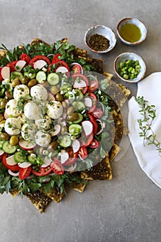 Beautiful plate display of homemade Labane cheese balls with Olive oil, za`atar pita bread toast and fresh vegetabl