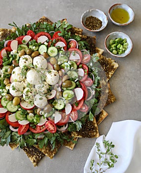 Beautiful plate display of homemade Labane cheese balls with Olive oil, za`atar pita bread toast and fresh vegetabl