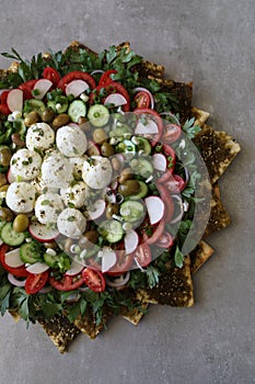 Beautiful plate display of homemade Labane cheese balls with Olive oil, za`atar pita bread toast and fresh vegetabl