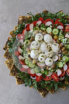 Beautiful plate display of homemade Labane cheese balls with Olive oil, za`atar pita bread toast and fresh vegetabl