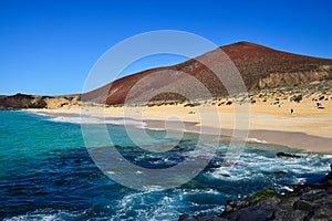 Beautiful Playa de las Conchas with Montana Bermeja in the background. The island La Graciosa, belonging to Lanzarote, Canary