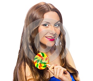 Beautiful playful girl holding a colorful twisted lollipop