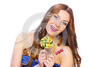 Beautiful playful girl holding colorful twisted lollipops