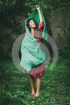 Beautiful playfull young woman in garden