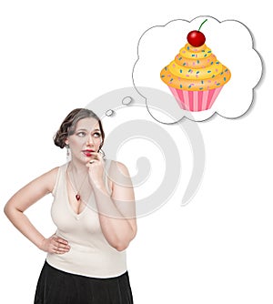 Beautiful plus size woman dreaming about cake