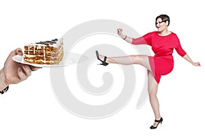 Beautiful plus size woman fighting off unhealthy food isolated