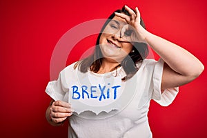 Beautiful plus size woman holding brexit banner for political referendum in europe with happy face smiling doing ok sign with hand