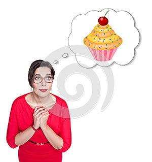 Beautiful plus size woman in red dress dreaming about cake