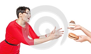 Beautiful plus size woman seduced with hamburger and pastry