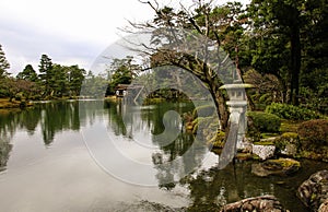 Beautiful pond and stone japanese lantern in Garden Kenrokuen in Kanazawa, Japan