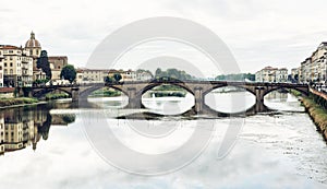 Beautiful Ponte Santa Trinita is mirrored in the river Arno, Flo