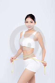 Beautiful portrait asian woman diet and slim with measuring waist for weight isolated