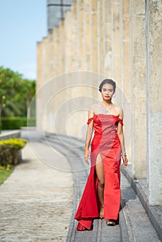 Beautiful portrait asian woman dress in red fashion evening dress act like model and look at camera.process in vintage style