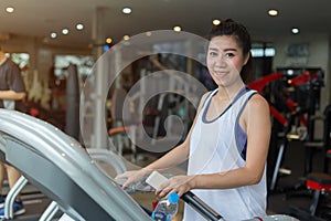 Beautiful portrait asian woman jogging and running on treadmill