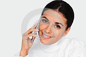 Beautiful portrait of attractive young happy woman with mobile phone with pretty toothy smile, on the white background.